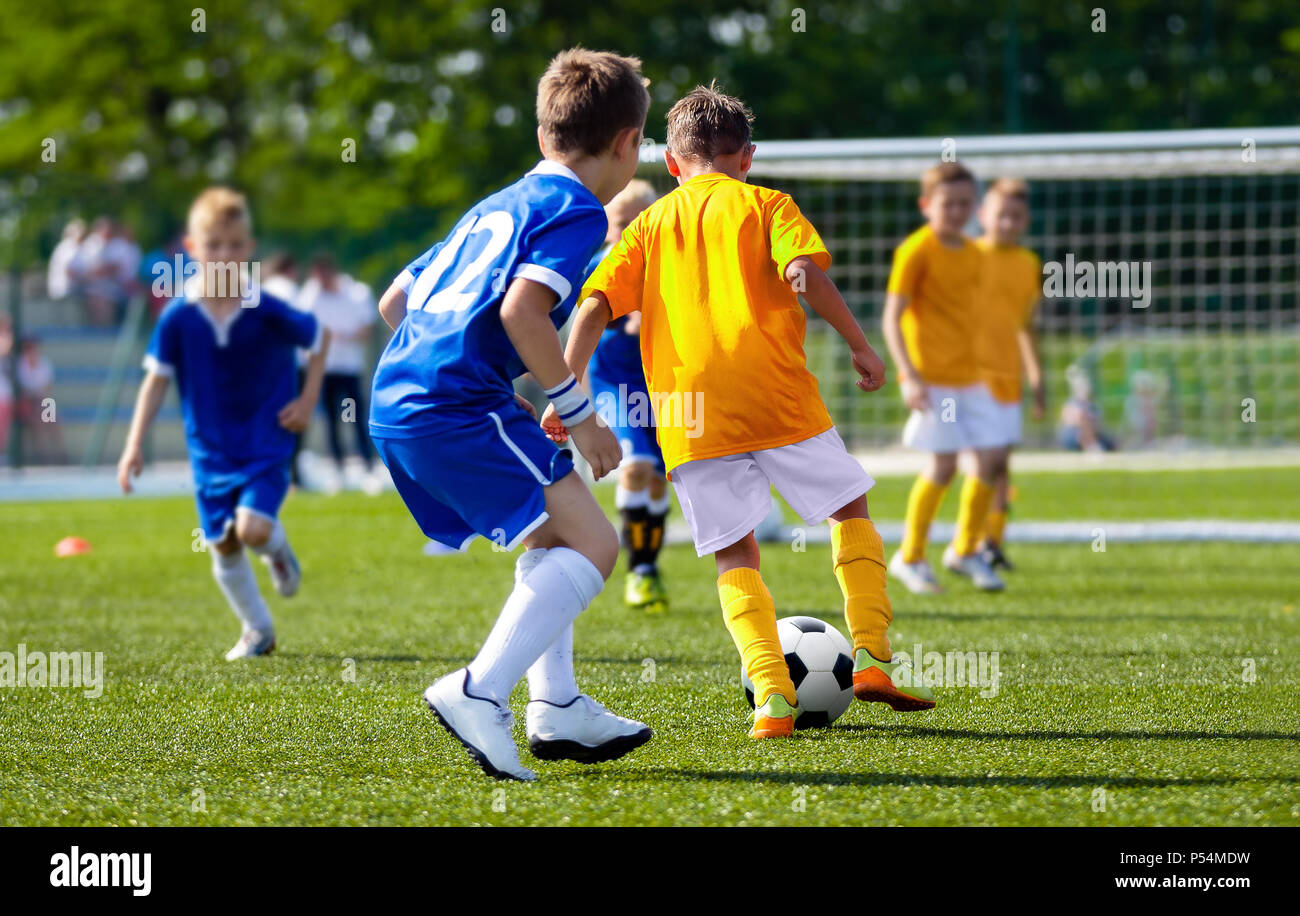 Football Player Running with the Ball on the Pitch. Footballers Kicking