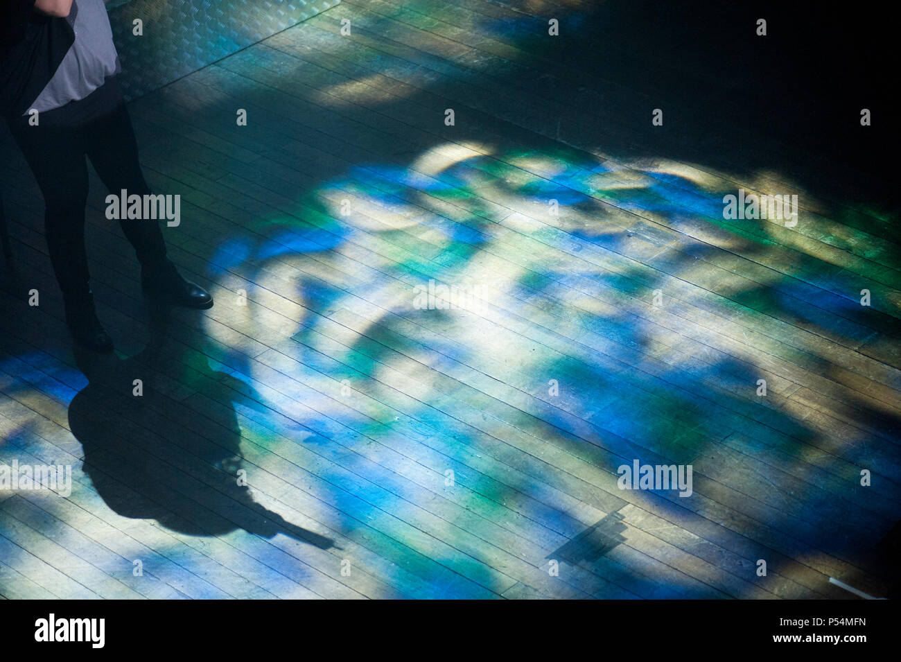 Rimini, Italy - circa February 2011 - Actor preparing for performance. Indoor colorful lightning of a small theatre stage Stock Photo