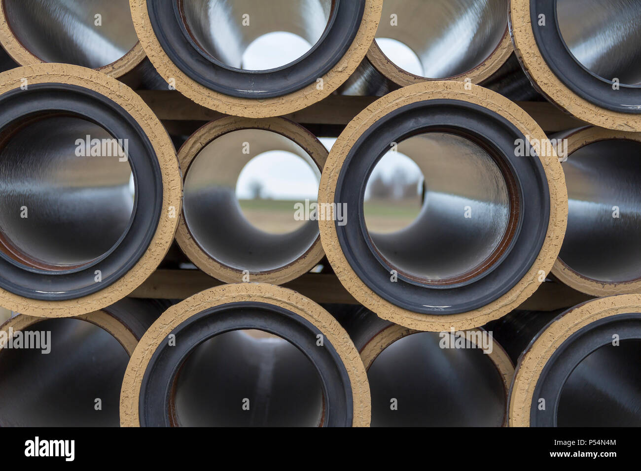 full frame abstract closeup shot of some stacked earthenware pipes Stock Photo