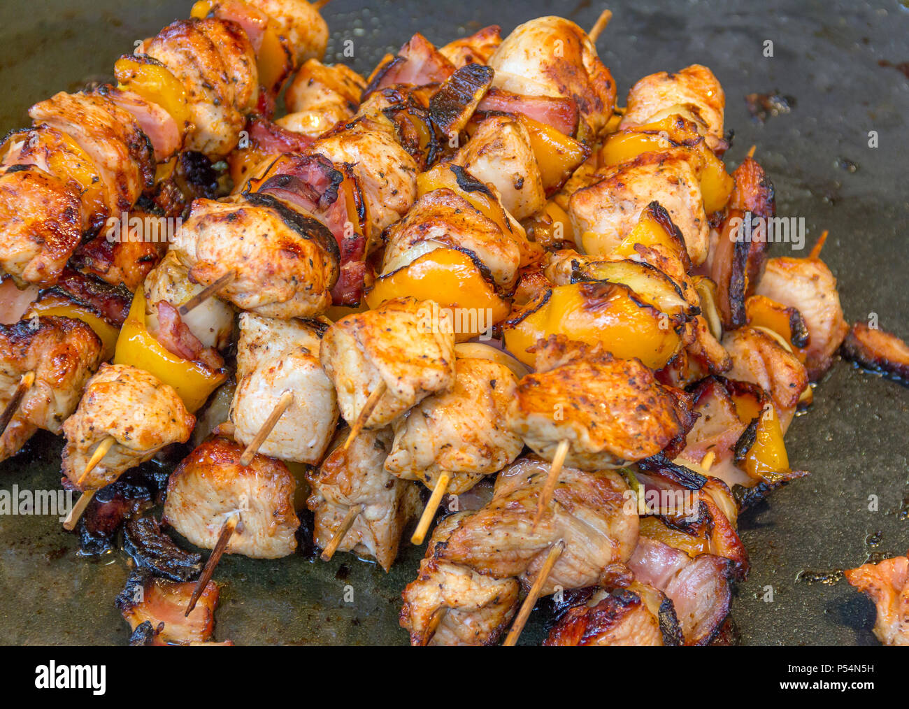 barbecue scenery with some roasted meat skewers Stock Photo