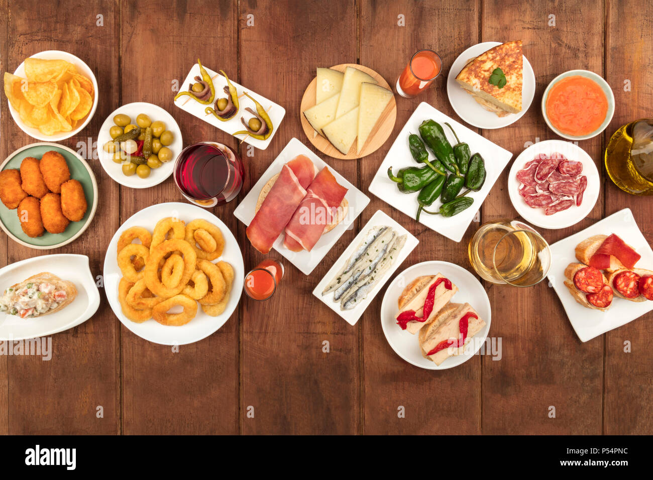 Overhead photo of many different Spanish tapas foods, shot from above