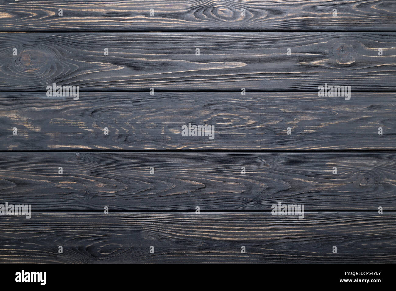 Dark gray background of wooden old rustic table, planks texture, wood wall. Stock Photo