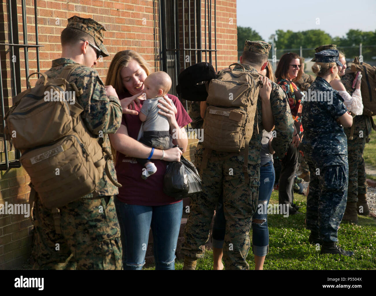 Family and friends greet their loved ones from 1st Platoon, Company C., Fleet Anti-terrorism Security Team, U.S. Marine Corps Security Force Regiment, returning home to Norfolk, Va. May 10, from a de-fueling assignment in Puget Sound, Washington. This platoon of Marines were gone for over five weeks providing security for nuclear submarines in order to de-fuel. Stock Photo