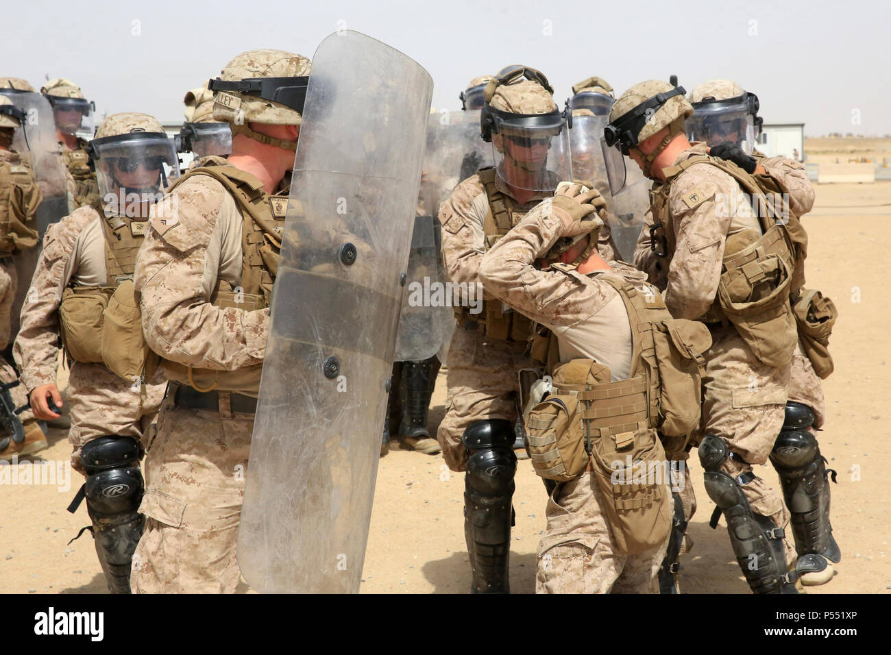 U.S. Marines with 1st Battalion, 7th Marine Regiment, Special Purpose Marine Air-Ground Task Force-Crisis Response-Central Command, confront a simulated aggressor during a one-week non-lethal weapons training class while forward deployed in the Middle East, May 9, 2017. The training ensures SPMAGTF Marines are prepared to respond to a variety of scenarios that may occur across the USCENTCOM area of operations. SPMAGTF-CR-CC is a well-trained crisis response unit that has the ability to project combat power over vast distances using organic aviation, logistical, and ground combat assets. Stock Photo