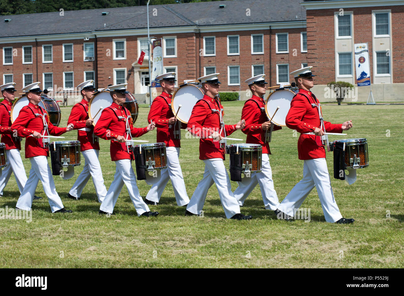The U.S. Marine Drum and Bugle Corps march off after performing in the Centennial Celebration