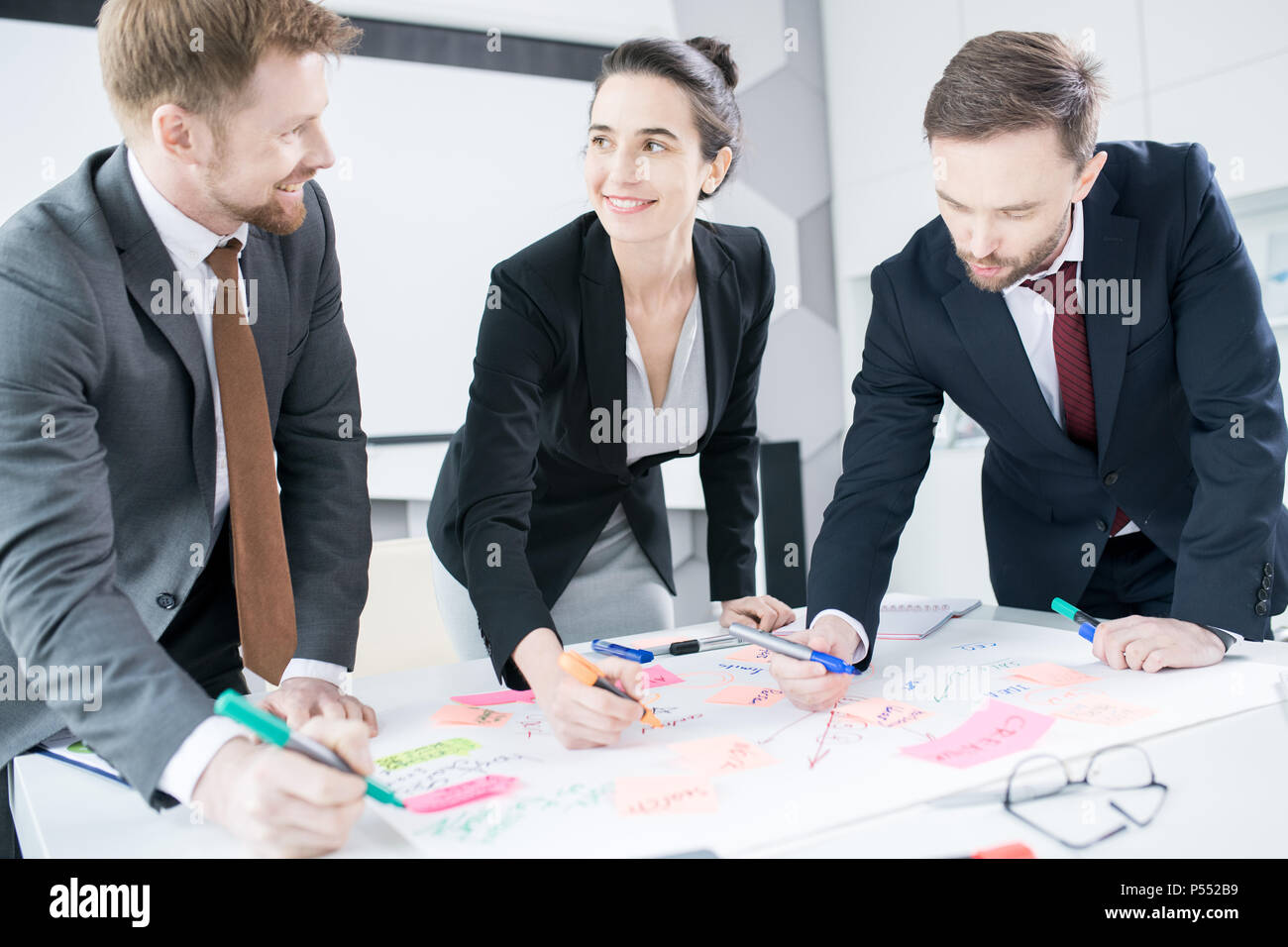 Cheerful Businesspeople Collaborating Stock Photo