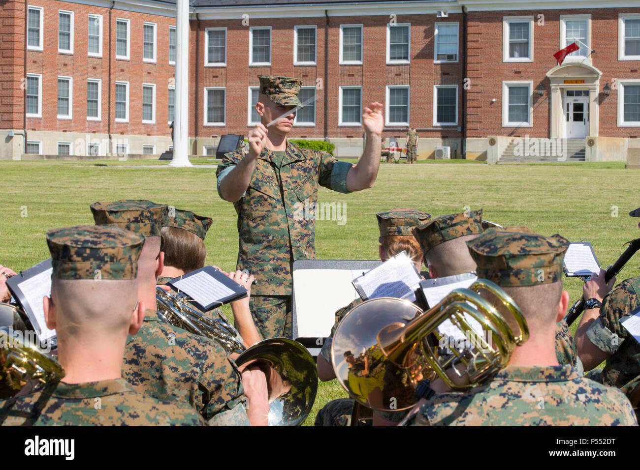U.S. Marine Corps Gunnery Sgt. Kristofer P. Hutsell, center, enlisted conductor, Headquarters & Service Battalion, conducts the U.S. Marine Corps Quantico band during the Centennial Celebration Ceremony at Lejeune Field, Marine Corps Base (MCB) Quantico, Va., May 10, 2017. The event commemorates the founding of MCB Quantico in 1917, and consisted of performances by the U.S. Marine Corps Silent Drill Platoon and the U.S. Marine Drum & Bugle Corps. Stock Photo
