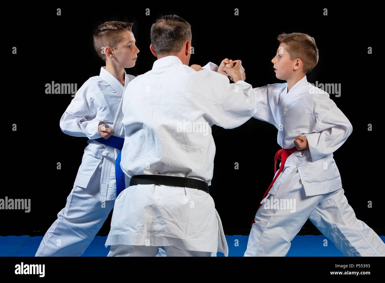 Male karate instructor training little children in dojo Stock Photo - Alamy