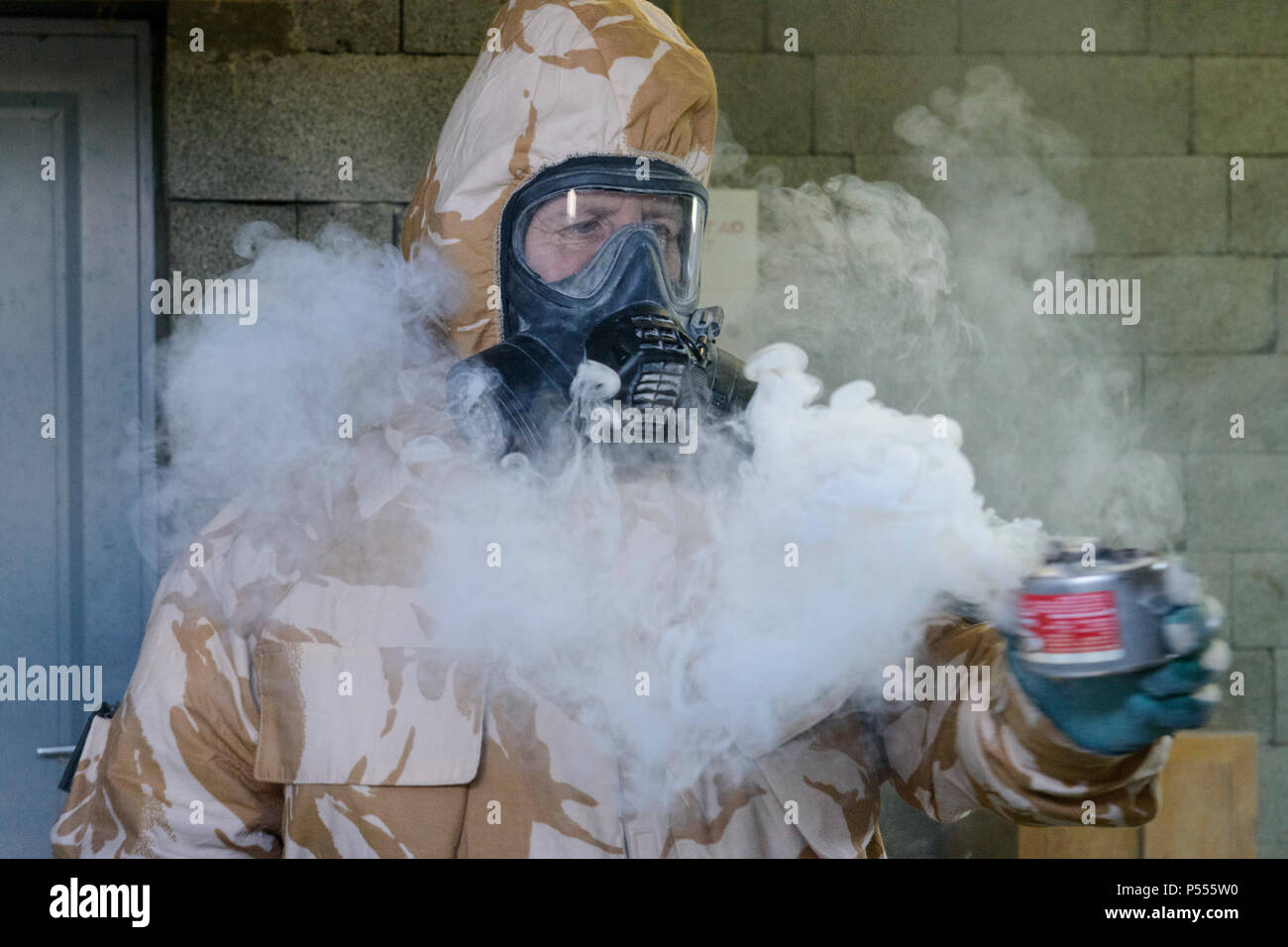 A British Senior Noncommissioned Officer, with the Joint European Training Team, spreads the CS gas inside the U.S. Army Training Support Center Benelux Chemical, Biological, Radiological and Nuclear facility on Chièvres Air Base, Belgium, May 09, 2017. Stock Photo