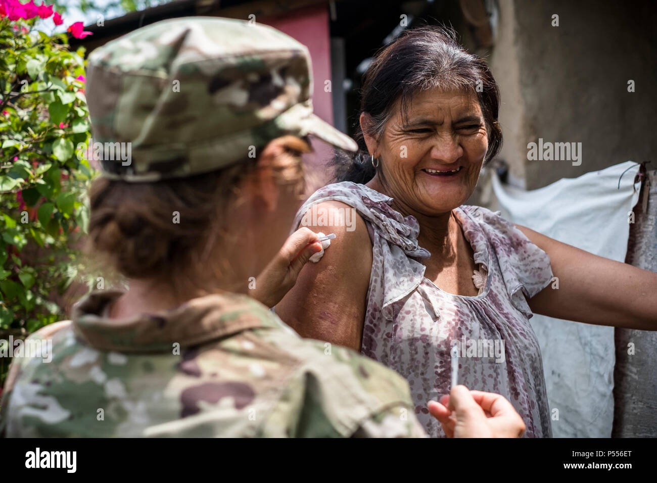 U.S. Army Lt. Col. Rhonda Dyer, Joint Task Force - Bravo, gives a vaccine to a local Honduran while out on a Community Health Nurse mission in Comayagua, Honduras, May 10, 2017. The CHM is a weekly partnership with the staff at Jose Ochoa Public Health Clinic, administering vaccines, Vitamins, deworming medication and other medical supplies to over 180 Hondurans around the Comayagua area on May 10, 2017. Stock Photo