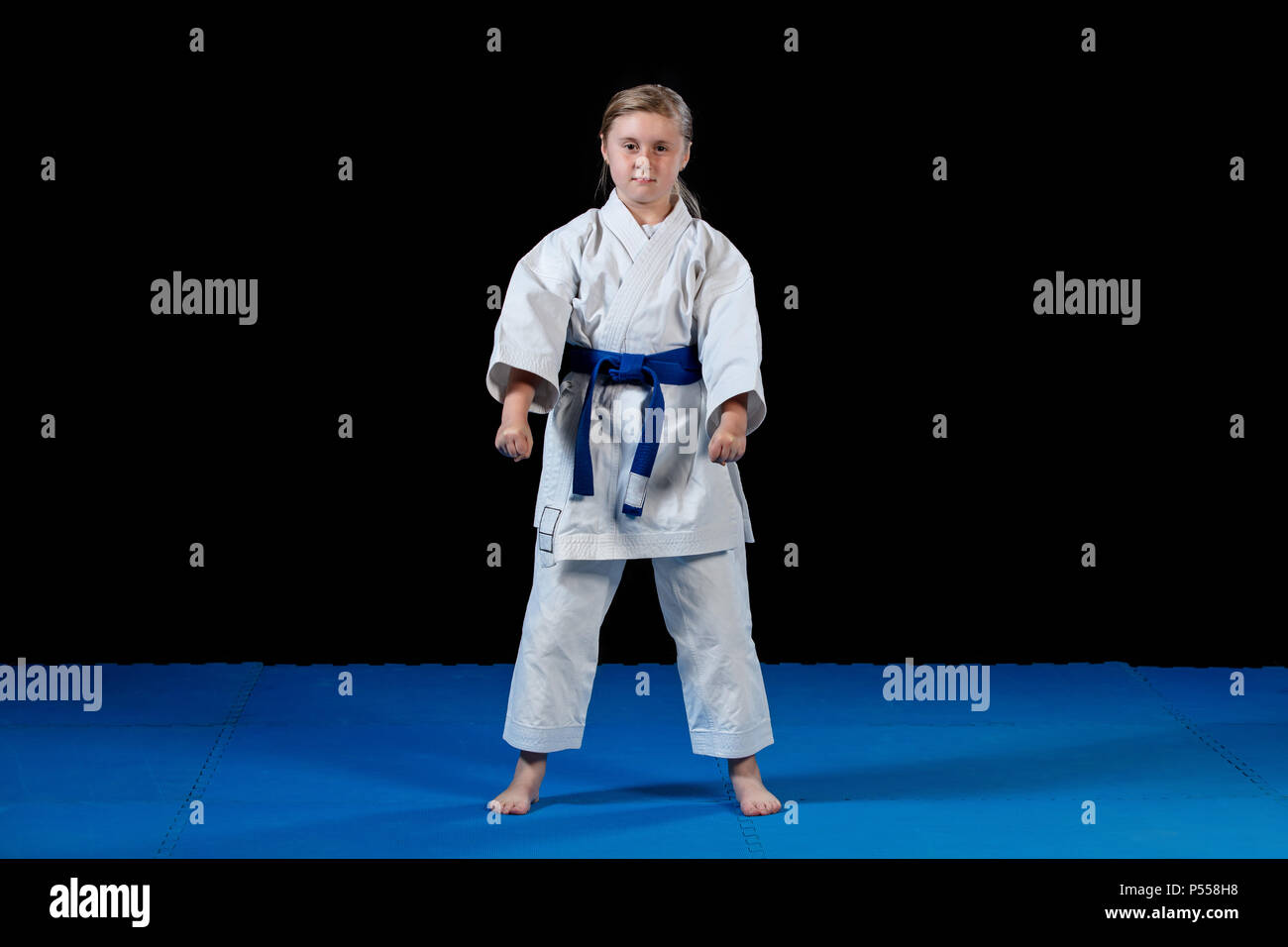 sweet little girl in martial arts practice like karate kid alone