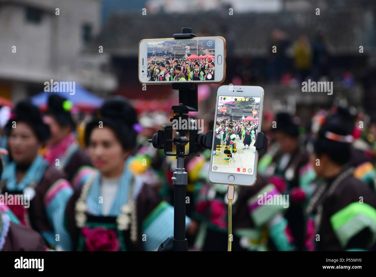 (180625) -- BEIJING, June 25, 2018 (Xinhua) -- Photo taken on Feb. 20, 2018 shows a mobile phone live broadcast of a Spring Festival celebration event in Jiumen Village of Danzhai County, southwest China's Guizhou Province. For most Chinese in the 1970s, one of their dreams was to own 'three wheeled things and one vocal thing' which, namely, were a bicycle, a sewing machine, a watch and a radio. By and large, this dream became easily accessible during the 1980s and the 1990s, and 'the big four' were replaced by TV set, refrigerator, washing machine and tape recorder. With people's ever-growi Stock Photo