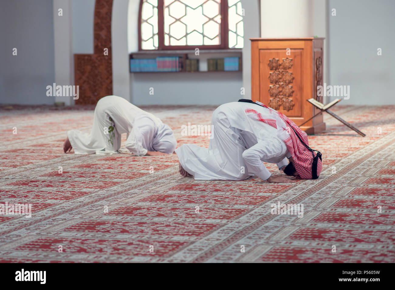 Muslim man and woman praying for Allah in the mosque together Stock ...