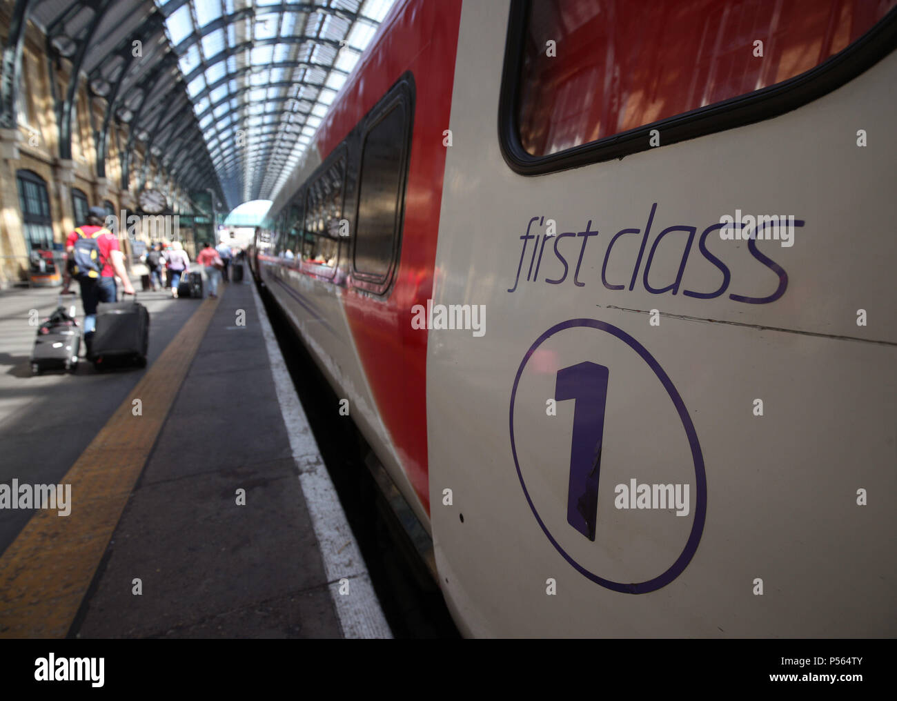 Passengers boarding a London North Eastern Railway (LNER) train during the launch event for the new service, which replaces the failed rail franchise Virgin Trains East Coast (VTEC), at Kings Cross station in London. Stock Photo