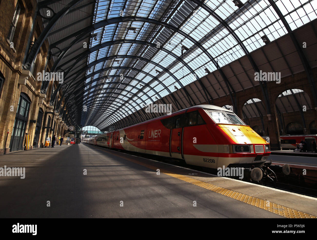 A London North Eastern Railway (LNER) train arrives at a platform during the launch event for the new service, which replaces failed rail franchise Virgin Trains East Coast (VTEC), at Kings Cross station in London. Stock Photo