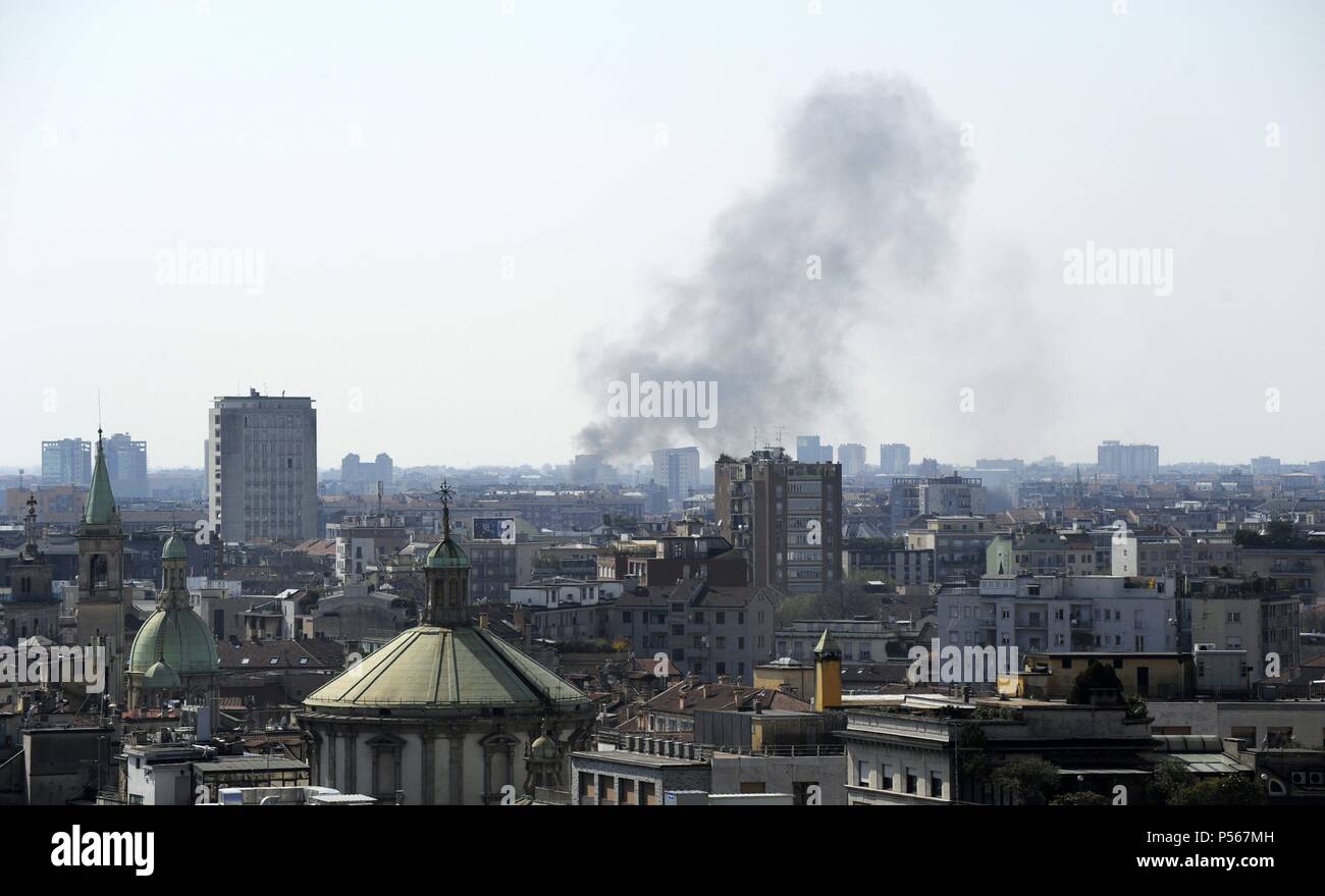 Large plume of smoke seen over Milan. Italy. Stock Photo