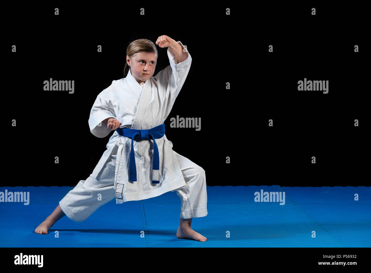 sweet little girl in martial arts practice like karate kid alone