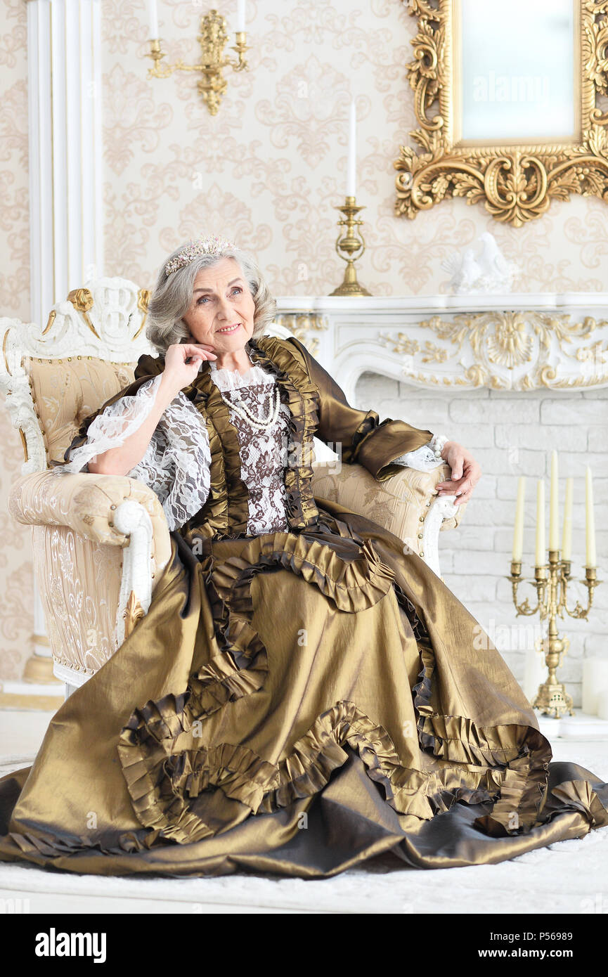 senior woman sitting in vintage chair Stock Photo - Alamy