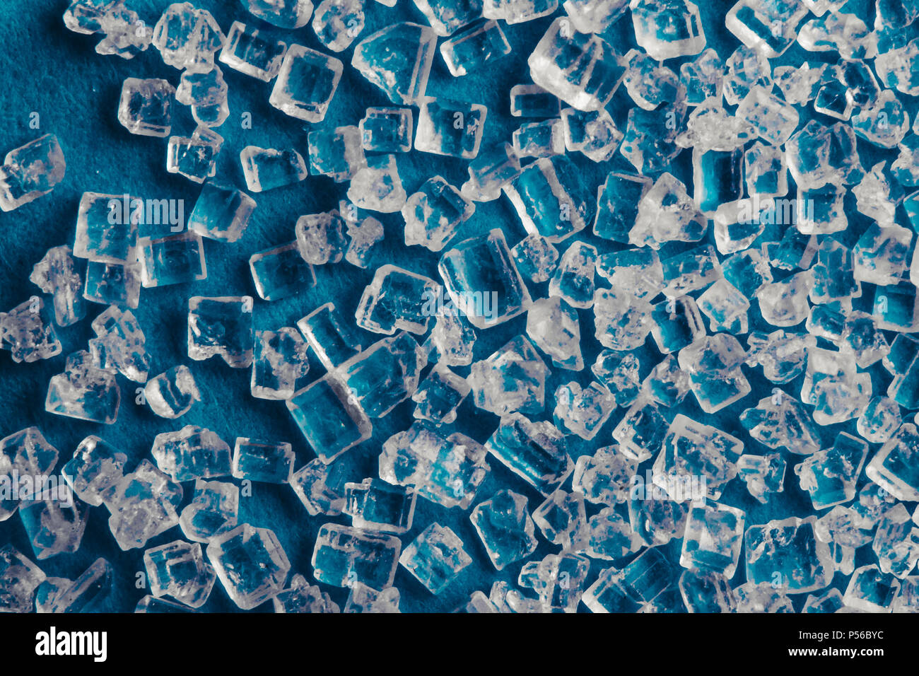 Background texture of sugar crystals on a blue background Stock Photo