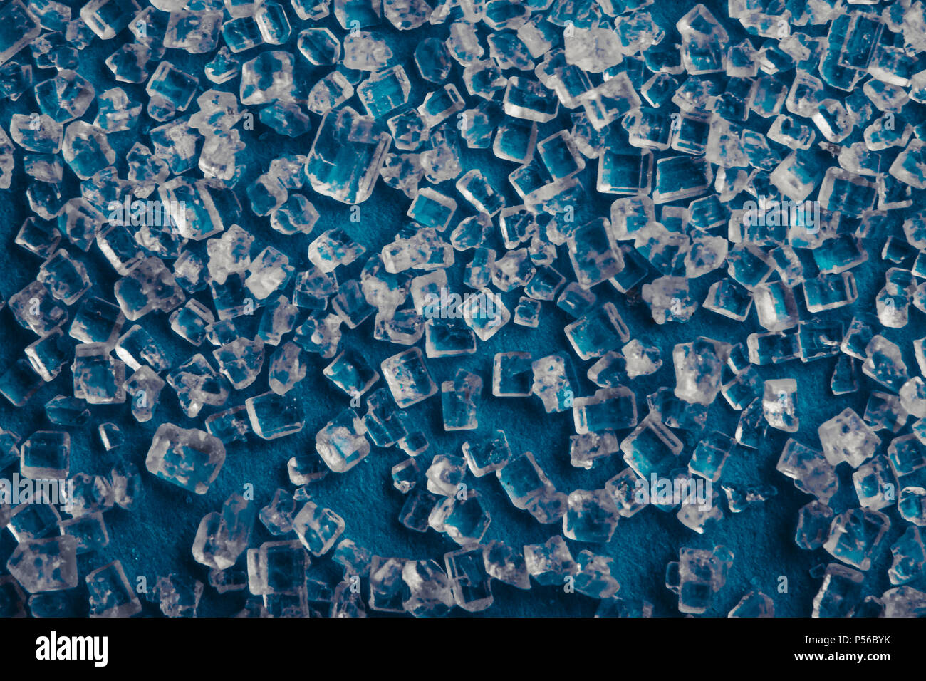Background texture of sugar crystals on a blue background Stock Photo