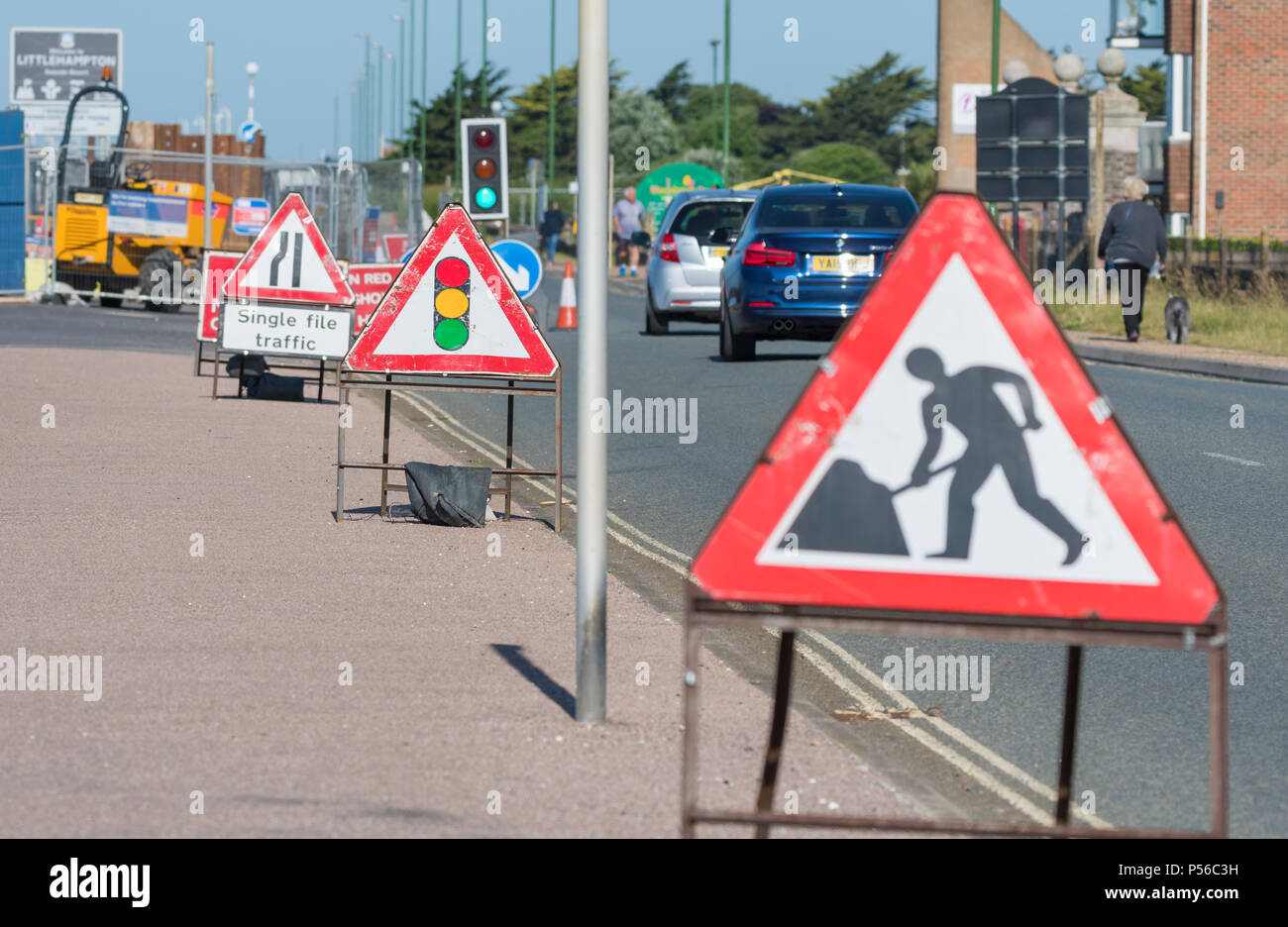 Temporary traffic lights at roadworks on a road in the UK Stock Photo