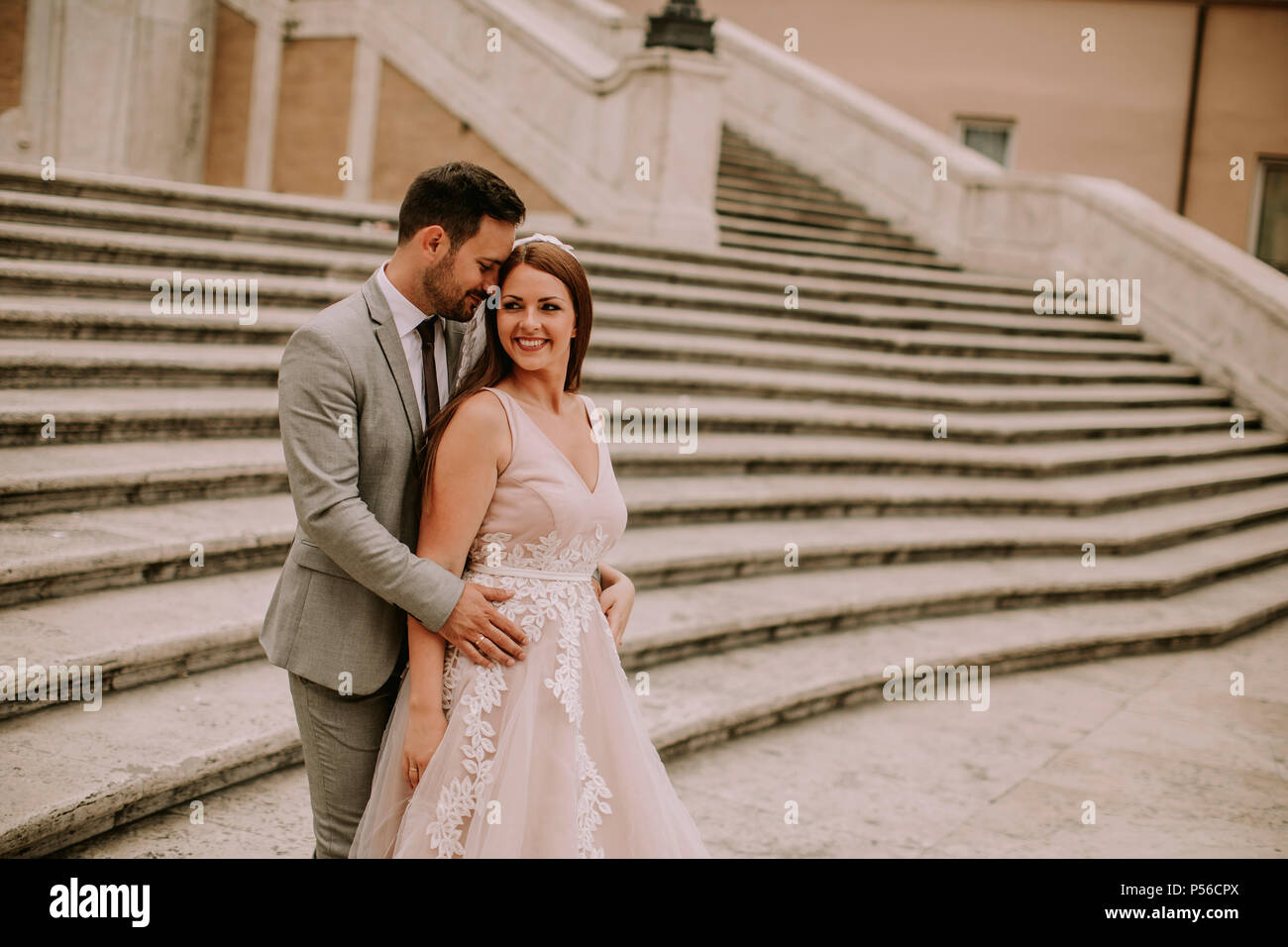 Young wedding couple on Spanish stairs in Rome, Italy Stock Photo