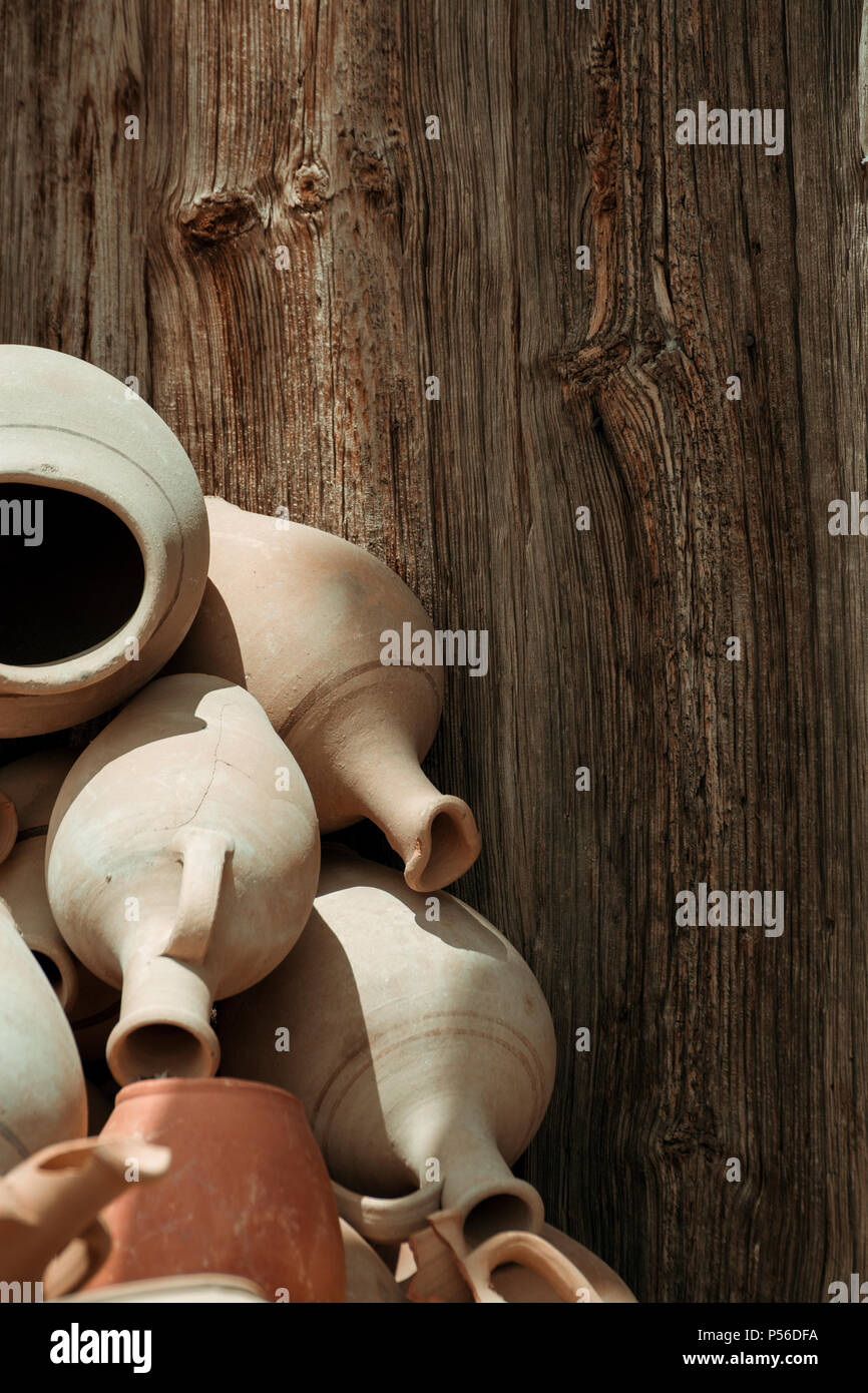 Many handmade old clay pots on the wooden background Stock Photo