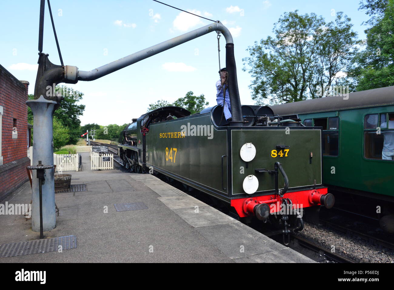 A steam train refueling with water Stock Photo Alamy