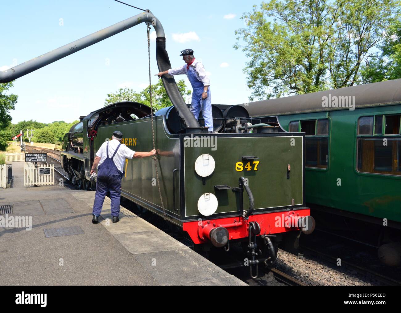 A steam train refueling with water Stock Photo Alamy