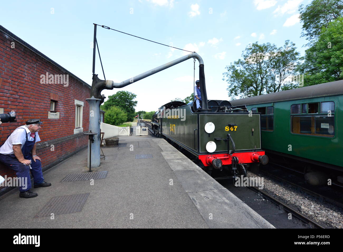 A steam train refueling with water Stock Photo Alamy