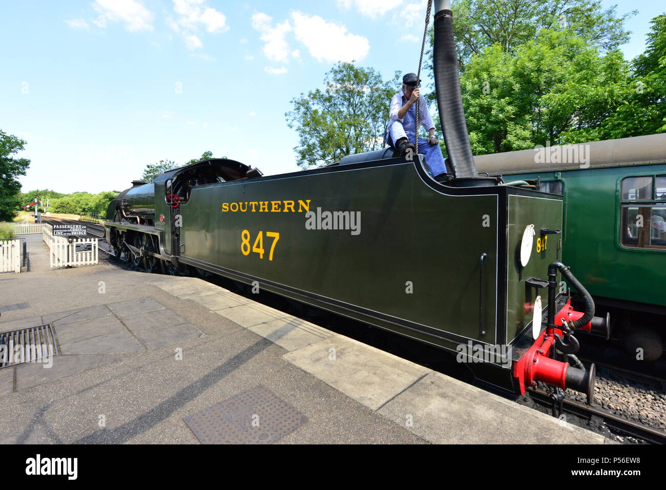 A steam train refueling with water Stock Photo Alamy