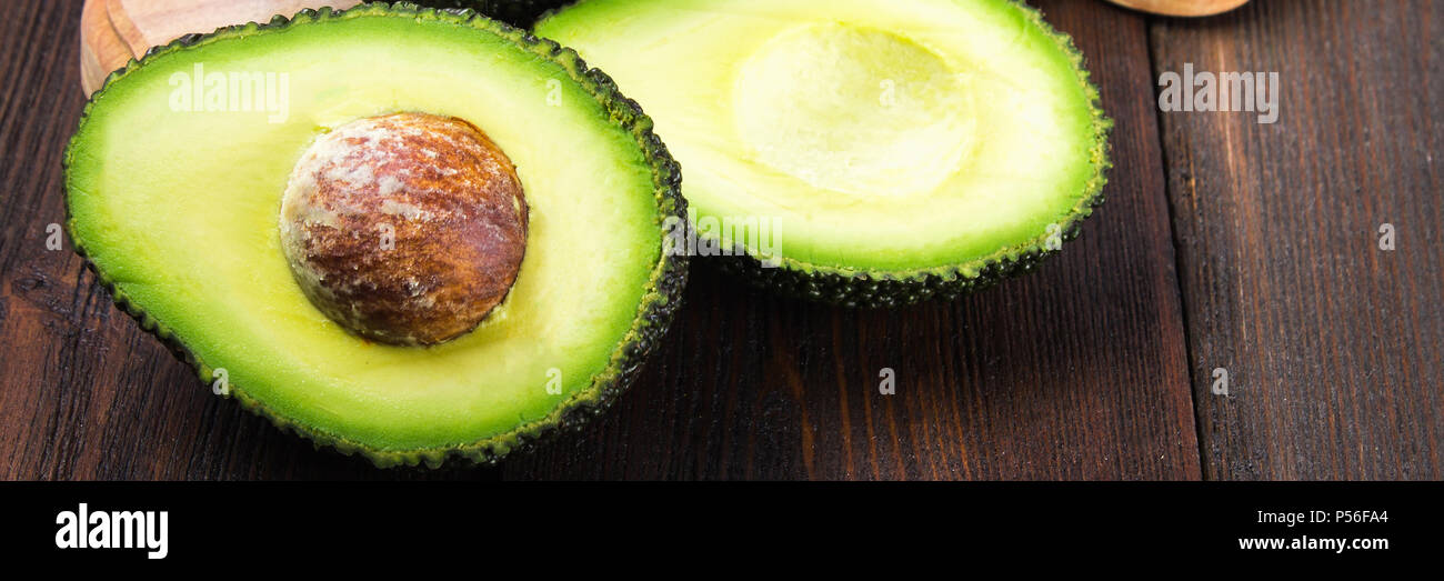 avocado on a dark wood background. tinting. selective focus Stock Photo