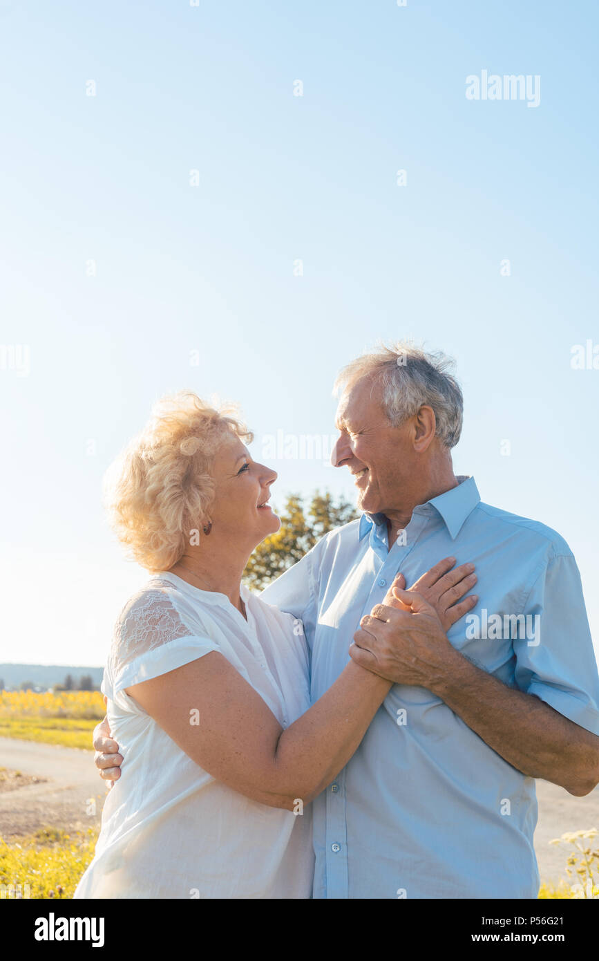 Romantic elderly couple enjoying health and nature in a sunny day Stock Photo