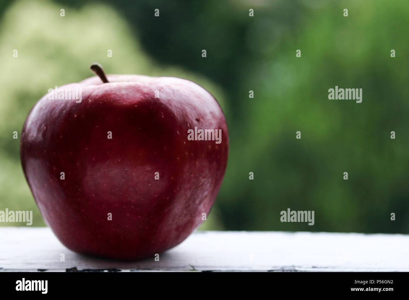 Red apple on a green background Stock Photo