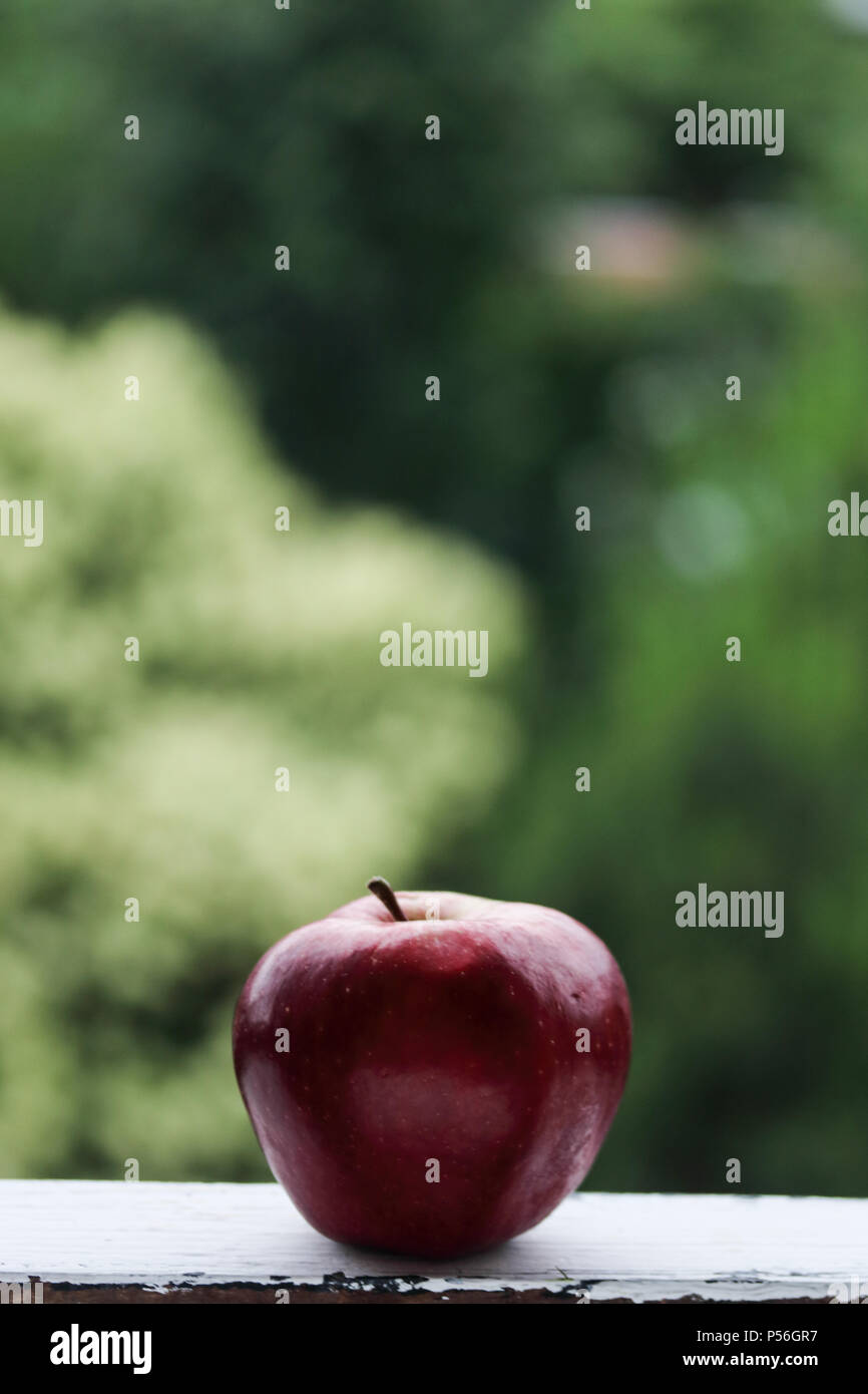Red apple on a green background Stock Photo - Alamy