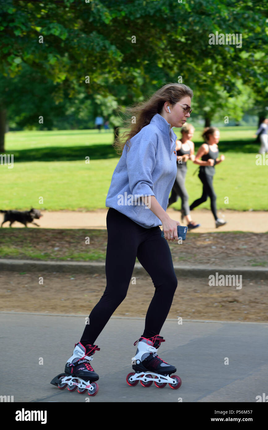 Young woman in-line skating, Hyde Park, London, United Kingdom Stock Photo