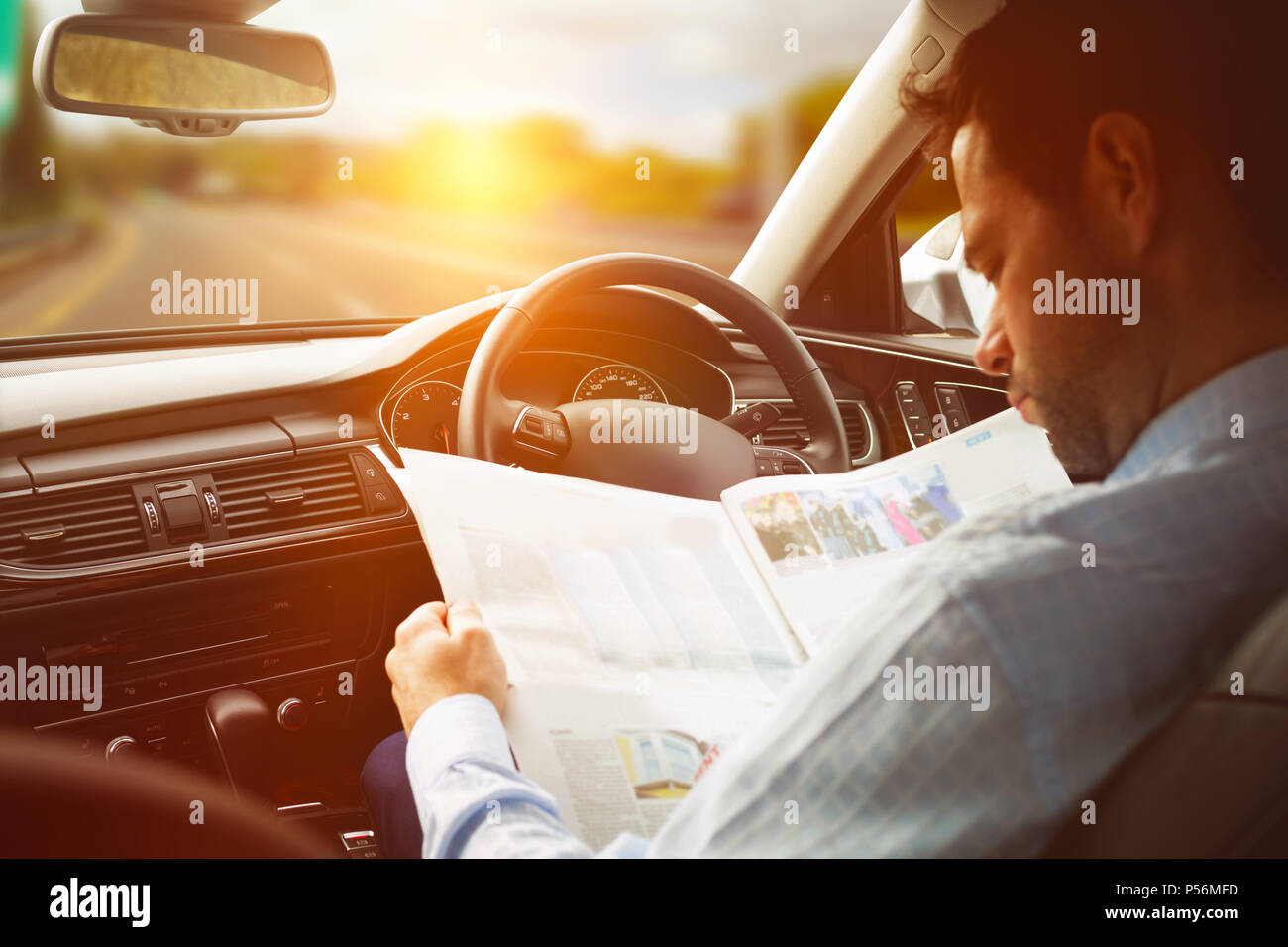 The person looking at the map hi res - Man Sitting In Car And Looking At Road Map P56MFD