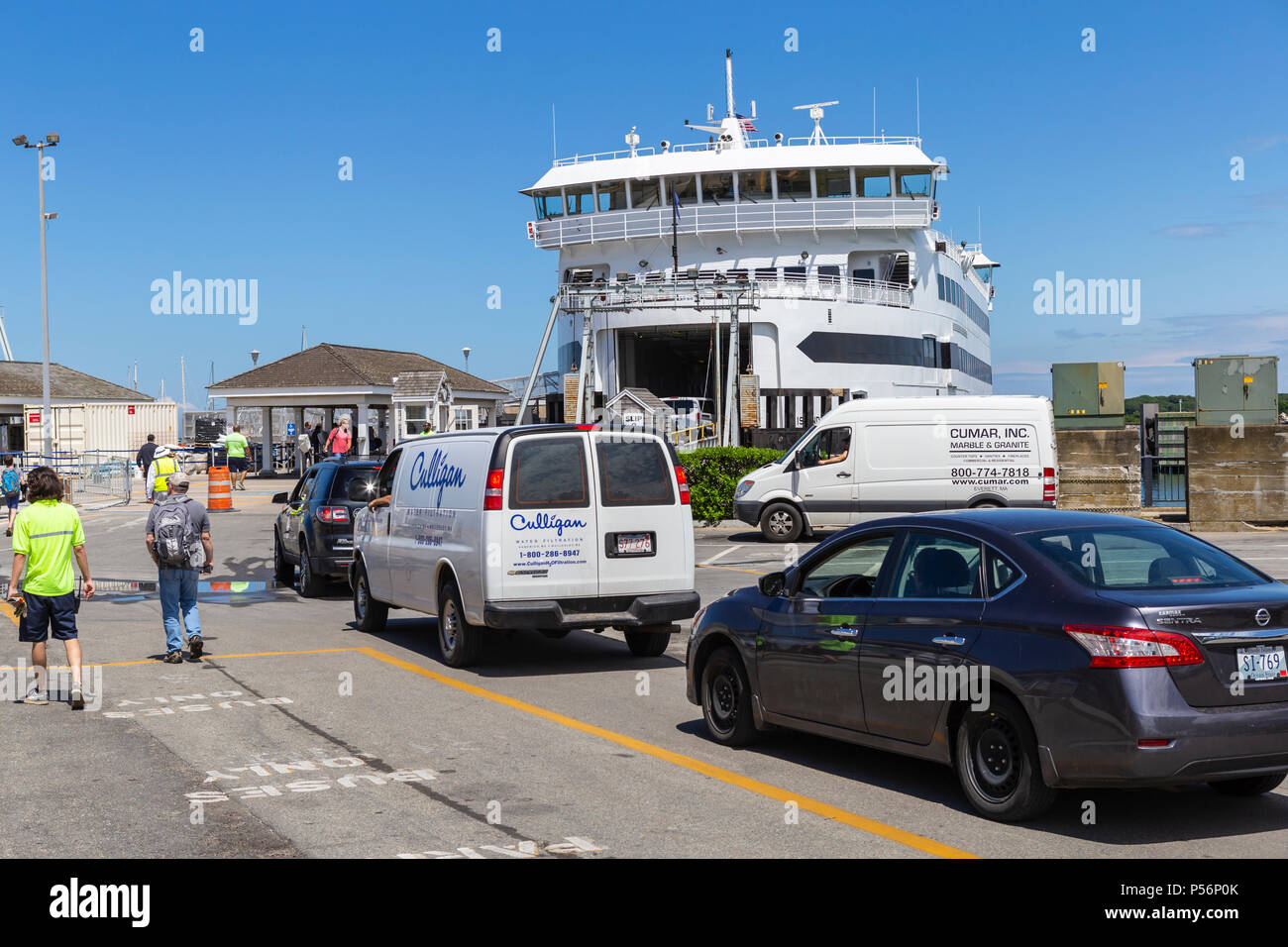 Vehicles and passengers are loaded aboard a Steamship Authority ferry 'MV Island Home' in Vineyard Haven on Martha's Vineyard. Stock Photo