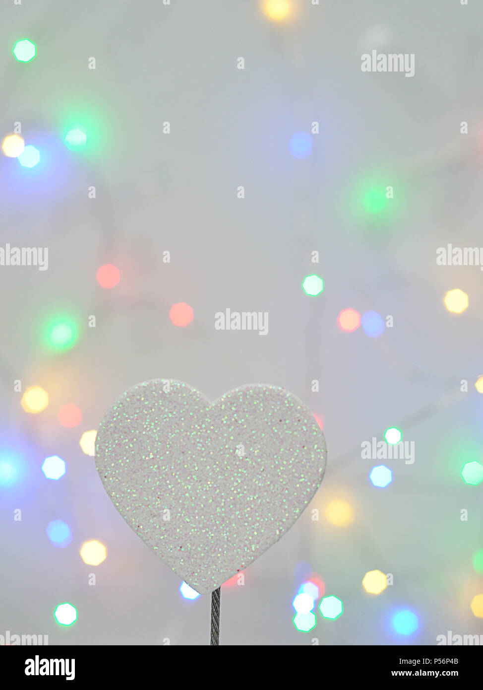 A white glitter heart isolated against an out of focus light background  Stock Photo - Alamy