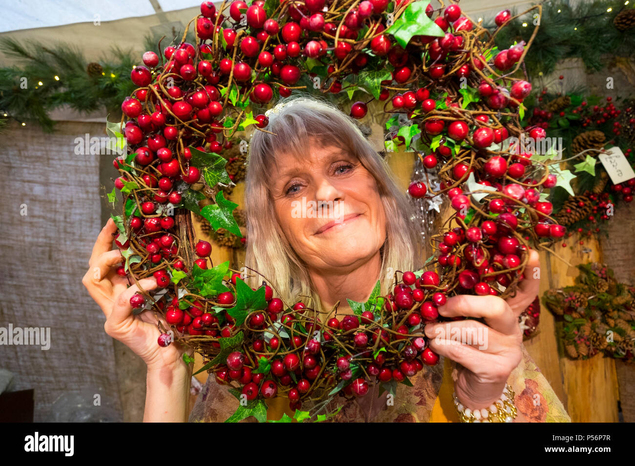 Woman with Christmas holly holywreath at Medieval Christmas Fayre at Ludlow Castle, Shropshire, England, UK Stock Photo