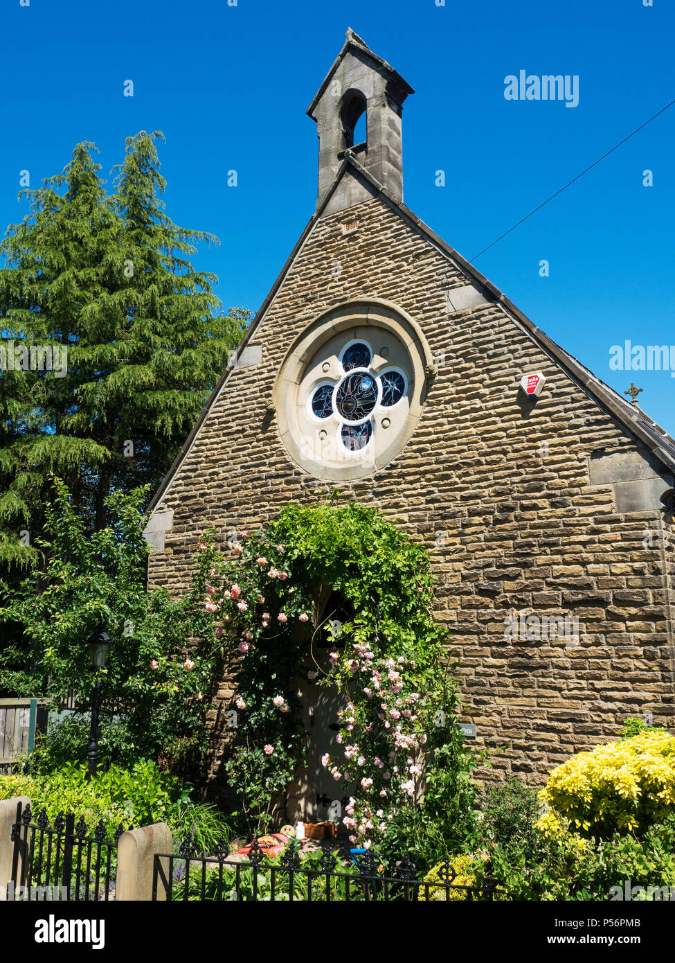 Old church converted to a house with roses round the door at Calcutt Knaresborough North Yorkshire England Stock Photo
