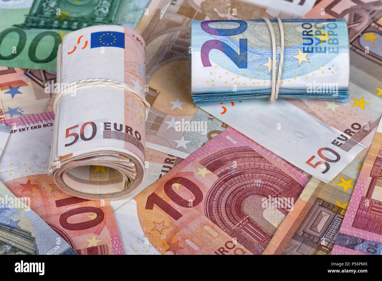 Many euro bills some of them rolled up Stock Photo - Alamy