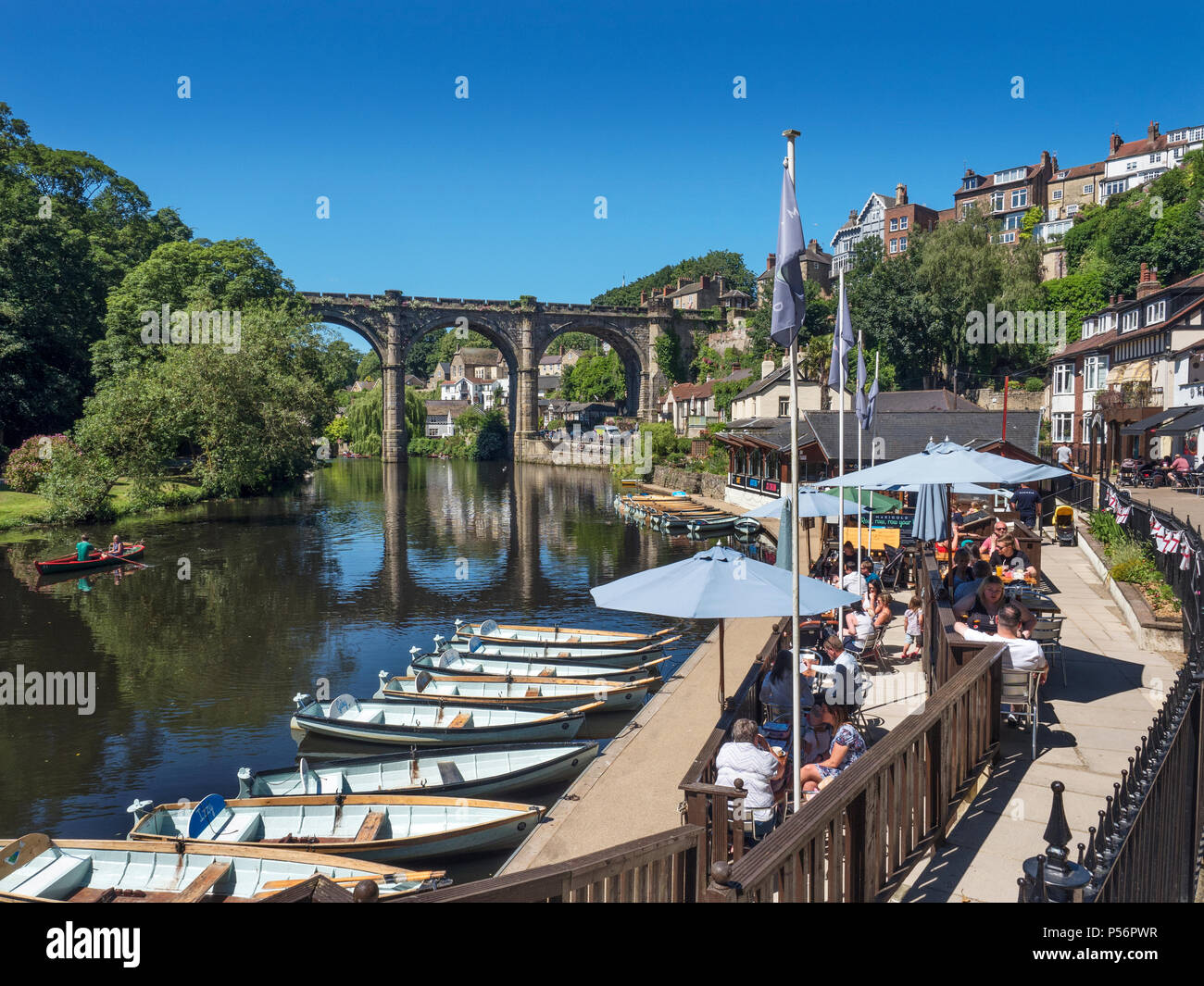 Riverside cafe and railway viaduct from Waterside on a summer day in Knaresborough North Yorkshire England Stock Photo