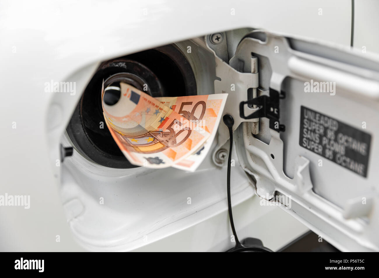transportation expenses concept - euro money in car fuel tank Stock Photo