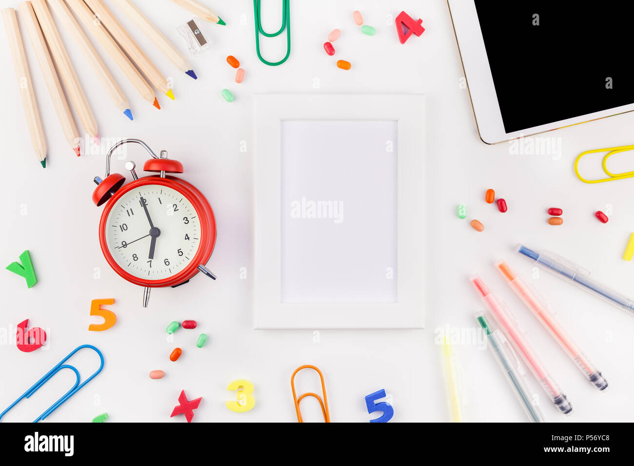 Creative flat lay back to school concept blank tablet with alarm clock ...