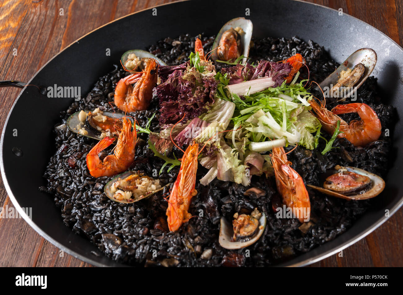 Paella,Seafood with black rice Stock Photo - Alamy