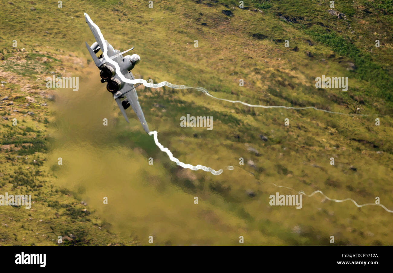 F-15E Strike Eagle of RAF Lakenheath 48th Fighter Wing, flying low level in the mach loop area of Wales (LFA7, low flying area 7) near Snowdonia Stock Photo