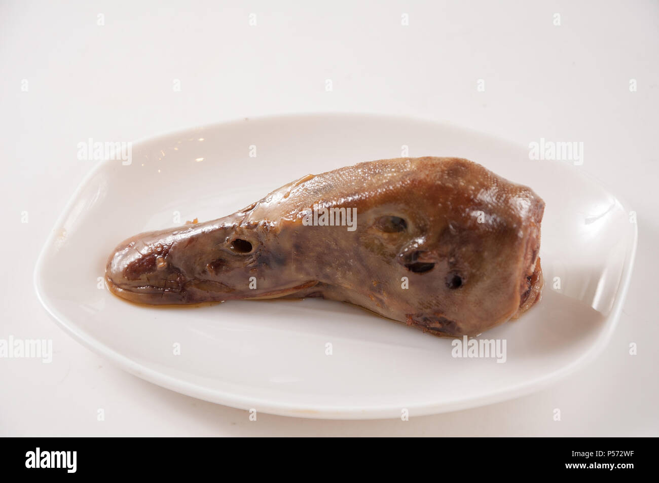 marinated duck heads, Chinese cuisine on white plate Stock Photo Alamy