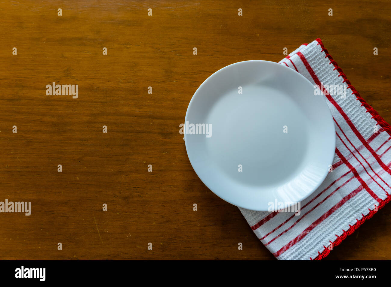 Empty plate on wooden table. View from the top. Stock Photo