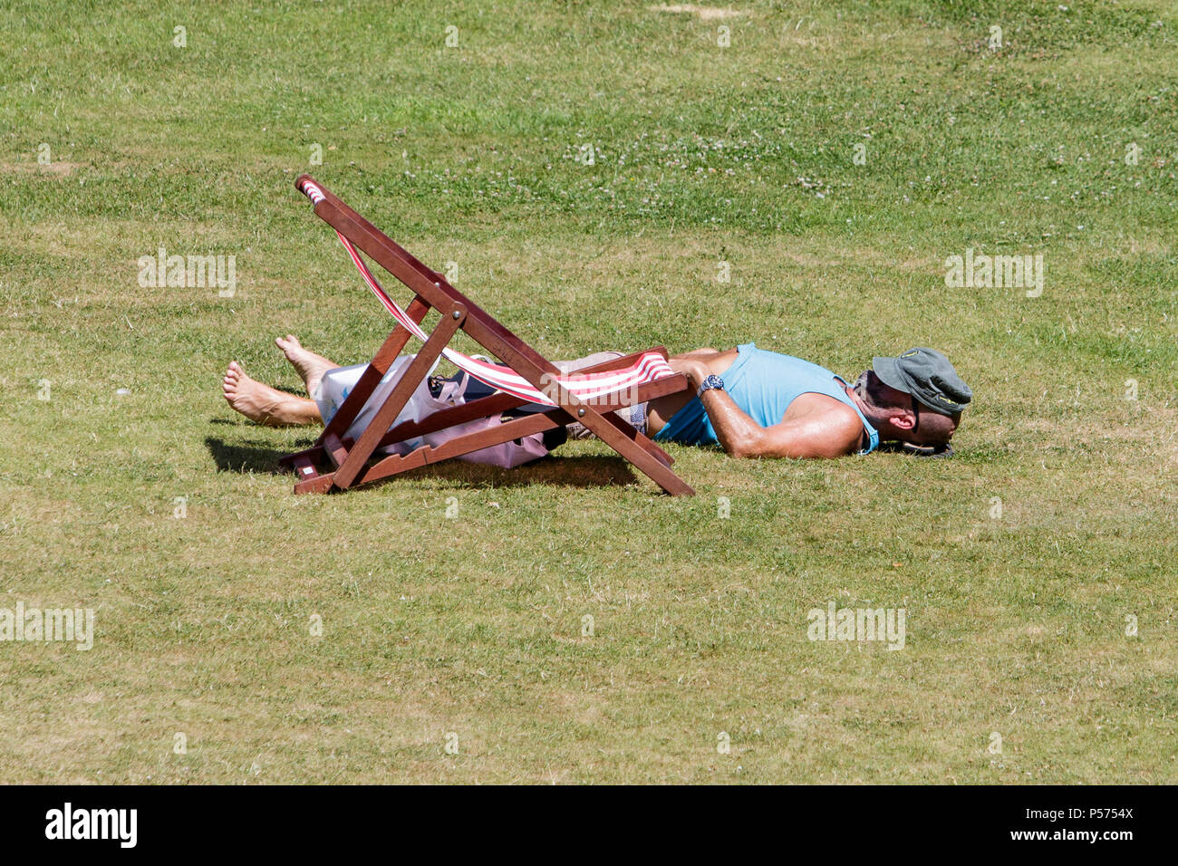Bath, UK, 25th June, 2018.  As Bath enjoys another hot and sunny day a man in Bath's Parade Gardens is pictured taking advantage of the good weather and warm sunshine, forecasters predict that the warm weather will continue into next week. Credit: lynchpics/Alamy Live News Stock Photo